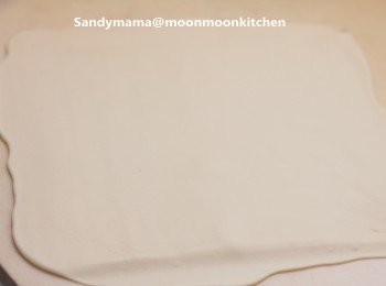 step3: 3.在工作枱上，灑上少許手粉，取出麵糰，擀薄成半厘米厚，兩份麵糰面積相約。