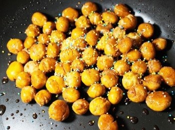 step7: 準備另一個鍋，下蜜糖開小火，加入炸好的麵糰，滾動麵至每粒也沾上蜜糖後，洒上彩糖即成