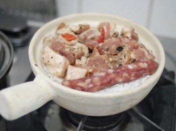 step3: 然後轉小火，下排骨及臘腸，蓋上鍋蓋，煮約15分鐘，關火，再焗15分鐘即成！（如想有較多飯焦，在最後用中火煮數分鐘）