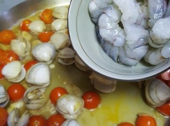 step3: 熱鑊下油放入蒜片爆香，加入蕃茄仔炒勻，加入珍珠蜆略炒，倒入白酒加蓋煮至珍珠蜆熟，加入蝦略炒