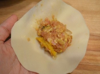 step16: 取適量的蟹粉肉饀放在麵皮上攤平。