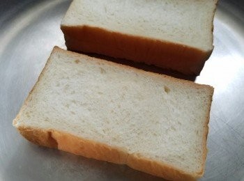 step1: 將麵包一面塗上牛油。先將無牛油一面先放平底鍋煎至金黃色（不需要加油）。當一面已煎好，開始煎牛油一面，亦都煎至金香。