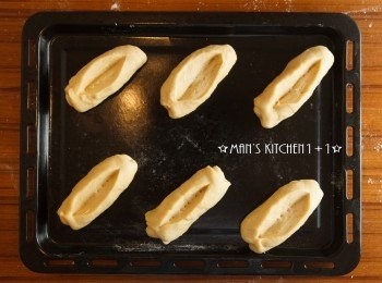 step9: 接著從短邊往內縮收折麵團成長的橄欖型狀後用刀子在麵團上切一個缺口，並再次發酵約50分鐘。