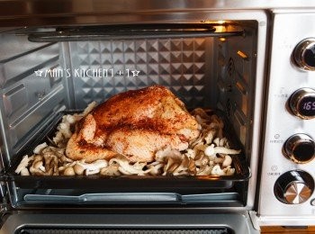 step5: 接著將全雞鋪在蕈菇上頭後放入烤箱用165度烘烤90分鐘就完成了。這台烤箱因為有微電腦LED旋鈕，所以溫度和時間都可以精準設定，很方便使用。另外這台也有附雞叉，可以360度旋轉，下次烤雞時也可以這樣烤試試看。