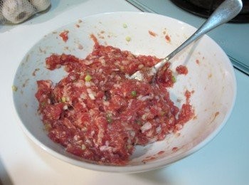 step1: 將絞肉加入蛋攪拌到有黏性，再加入鹽、胡椒各1/2茶匙、醬油1茶匙，繼續攪拌直到均勻。最後加入蔥花攪拌均勻後放置一旁備用。