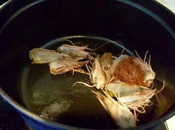 step2: 下油炒香蝦頭及冬蔭功醬，加水滾起後中火煮5分鐘