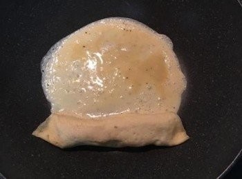 step9: 接著再次倒入蛋液，轉鍋攤成蛋皮。
趁未乾前，輕輕往前推捲起並放到鍋邊。