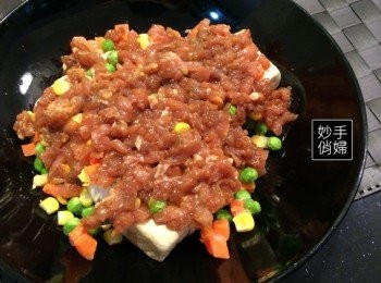 step3: 絞肉先用調味料醃過大約10分鐘左右~
接著一樣鋪在臭豆腐跟冷凍蔬菜最上層~