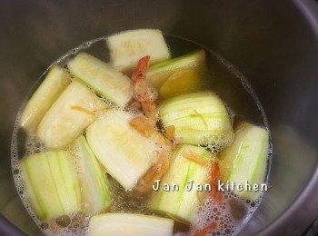 step2: 下少量油爆香薑片，下蝦乾炒香，放入節瓜稍煎一下，加入水煮滾，下瑤柱及鹹蛋黃，將材料煮熟後，加入鹹蛋白搞勻，下豚肉片快快撈熟即可。由於湯底有瑤柱及蝦乾已夠味，所以只放了少許麻油調味。我用的是薄薄的豚肉片，故最後才下。如用瘦肉可早一點放入可令湯更有味。