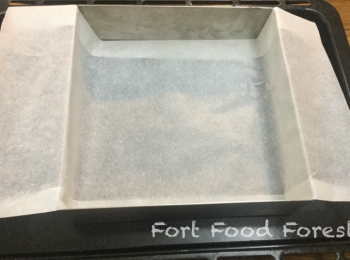 step9: 放一個8吋X8吋四方蛋糕盤在焗盤上, 然後鋪一張約16吋長8吋濶的焗爐紙墊蛋糕盤底, 焗爐紙兩端掛在蛋糕盤口兩邊, (即焗爐紙放成℧形), 方便完成後由焗盤取出成品.