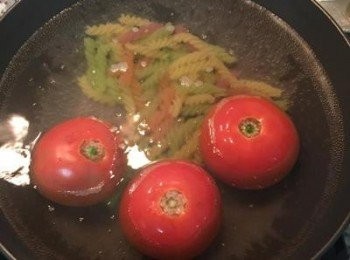 step2: 水滾後下2匙鹽，把螺絲麵和洗淨的蕃茄放入略煮，蕃茄要翻面喔～大約2-3分鐘即可把蕃茄取出，輕易去皮後切塊再切丁備用。 螺絲麵約煮5分鐘即可撈出備用。