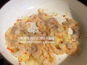 step4: 鑊下油爆香蒜蓉和辣椒，炒香洋蔥後放入鮮蝦煮熟，加入蟹柳，少許鹽和胡椒粉調味