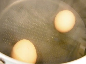 step2: 水滾後熄火，加入450毫升水喉水。再用湯勺慢慢把雞蛋加入水中，盡量不要碰撞到蛋殼以免令雞蛋破損。記緊水一定要完全蓋過雞蛋呀。