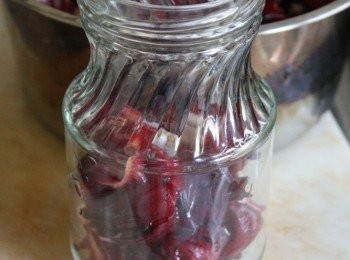 step6: 先放置一些洛神花到罐子裡去那，大約3分之一後，再用 湯匙舀一半