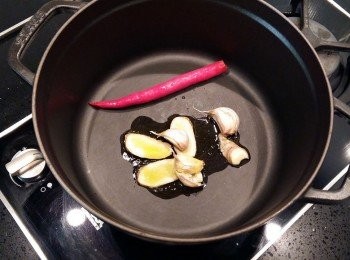 step3: 使用24cm的鑄鐵鍋,熱油鍋後放入蒜頭及薑片,辣椒爆香。