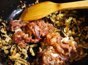 step3: 鍋子熱了之後倒進麻油與紅蔥酥，接著放入香菇絲、蝦米炒出香氣，  然後加入肉絲炒至七分熟