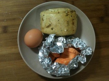 step1: 將冷凍堅果饅頭、生雞蛋和切塊地瓜放入盤中，置入電鍋，外鍋放一杯水，蒸煮。