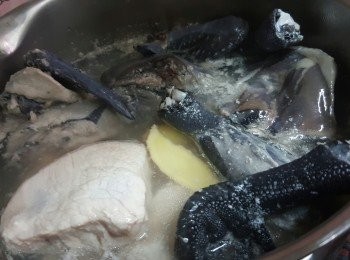 step5: 將烏雞去皮切大塊再洗淨；鍋倒入適量清水，放入瘦肉、烏雞和薑片，出水5分鐘