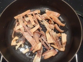 step4: 另準備一個淺鍋加入油後熱鍋,將乾魷魚放入鍋裡爆香。