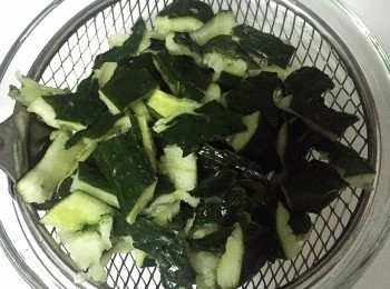 step3: 把青瓜放在筲箕上下鹽, 用手拌勻, 待15分鐘, 讓青瓜出水。