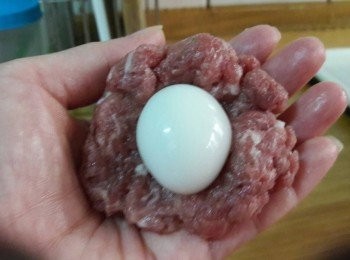 step4: 取適量的肉餡 , 壓平一下再把鵪鶉蛋一顆放入 , 把肉餡包起來 , 再搓揉成型
