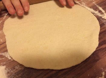step3: 薄餅底: 把剛才的麵團揉捏幾下, 分成兩個球。檯面上再放一點麵粉, 將其中一個球用麵粉棍滾壓成大約25cm的大圓薄餅底。薄餅底要夠薄, 因為焗的時候會脹起。將薄餅底放在放了麵粉的烤盤上。重複步驟將另一個球也做成薄餅底。