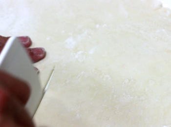 step7: 開始做北平蔥餅時, 先把面團分成兩塊, 可做出兩塊蔥餅。檊面時以中筋面粉做手粉, 不用太多, 不沾粘就可以了。檊至約35公分的圓型, 厚度會在2-3mm左右。從圓心往外劃一刀。