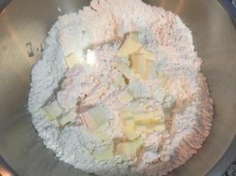 step1: 首先製造甜塔皮！把材料都先秤好,如果一顆蛋不夠50g,則可用鮮奶補足差量.將低筋麵粉、糖粉和鹽混合後，就可以倒入切小塊的無鹽奶油，接著用粉包覆奶油後再用手捏扁奶油，重複到粉和奶油都均勻混在一起成粗粉狀，
