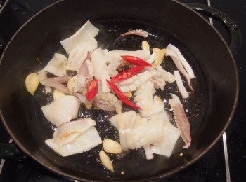 step4: 將醃製好的透抽下鍋用中大火做拌炒,再從鍋子邊緣淋上一大匙的米酒嗆出香氣。