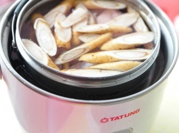 step3: 放入牛蒡切片與稍川燙過的雞翅於電鍋內鍋中，加入適量的水分開始燉煮