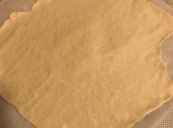 step2: 然後把麵粉放在牛油紙上的中間位置, 首先用麵粉棒用力的從中間向上下左右的推出去, 重覆這動作最少3次, 直至見到麵粉糰開始變得很薄, 最後用人手把麵粉輕輕的壓下去