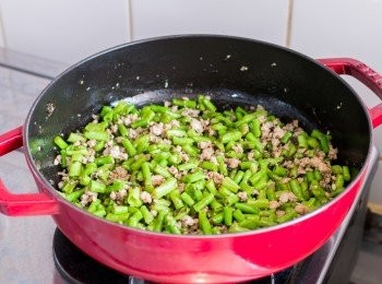 step5: 加入豆角兜炒約 3 分鐘後，下欖菜、蠔油、糖和水炒勻，蓋上焗煮約 2 分鐘。