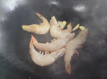 step1: 先用竹籤將蝦腸去除，洗淨，抹乾。燒熱油鑊，放下薑片，煎一會後放入蝦同煎。