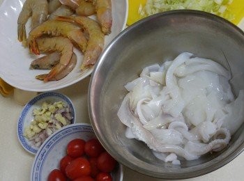 step1: 魷魚去皮切圈或切花式。蝦洗干淨剪去頭針，腳，去腸。洋蔥，乾蔥頭，蒜頭切碎。車厘茄在頂部切一刀。