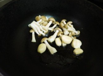 step2: 起鍋下少許的香油爆香蒜頭後，再下鴻喜菇，炒至香氣出來