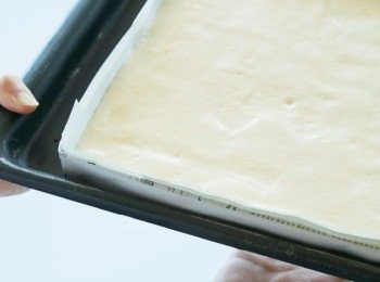 step11: 將麵糊放在烤盤上，敲打烤盤底部2～3次，排出麵糊內的空氣，接著放入預熱到200℃的烤箱（上層）中烤10分鐘。烤好後連同紙烤模一起倒扣，放在網架上散熱。