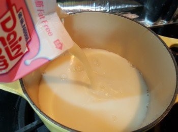 step3: 將鮮奶及糖倒入鍋中，用慢火煮至微滾(冒少許白煙)。