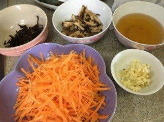 step2: 紅蘿蔔洗淨去皮切絲, 雞蛋煎成蛋皮切絲, 蒜頭切碎, 冬菇先浸軟榨乾水份後切幼條, 冬菇水留用, 木耳浸軟後瀝乾切絲備用