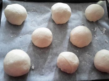 step4: 將麵糰拿出，用手按幾下麵糰讓空氣排出，將麵糰分成六至八份，搓圓。放在烘焙紙上，再用保鮮紙封口，靜置約45分鐘，作第二次發酵