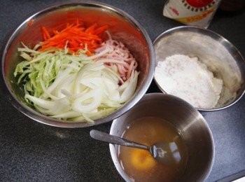 step1: 天婦羅粉/蛋黃/海鮮素/水攪拌成漿備用
 將所有疏菜同煙肉切成絲加入粉漿拌勻
 燒熱鑊加小許油倒入材料煎至金黃色反轉
 再煎至熟上碟灑上木魚絲同鰻魚汁即成.