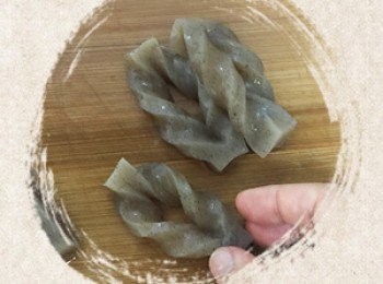 step8: 蒟蒻墨玉板切開卷起後，用熱水川燙1分鐘瀝乾備用。