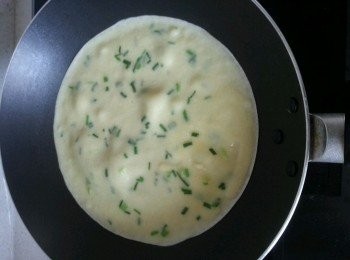 step2: 鍋熱後轉小火，離火，用湯勺舀一勺麵糊到鍋裡後迅速轉動鍋子，攤成圓形。（麵粉糊裡的麵粉會沉澱，每次舀麵糊都拿勺子攪拌一下。）