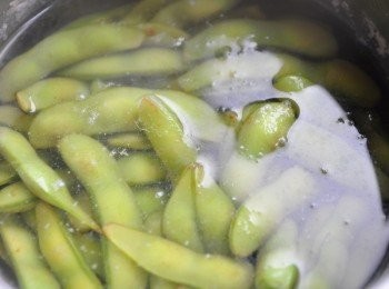 step1: 先將新鮮毛豆洗淨，再備一鍋水加入少許米酒和鹽巴滾煮川燙撈起