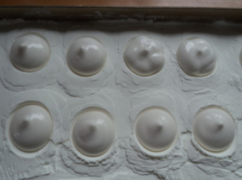 step12: 全部擠好後，用周圍的澱粉把棉花糖蓋住待它定型。