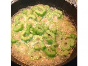 step5: 倒入適量的水，蓋鍋蓋燜煮到收汁，放入蔥段拌炒後起鍋，黃金苦瓜上菜。