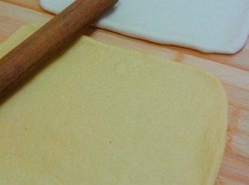 step3: 然后先将白面团擀成长方形后坦平在工作台上（南瓜层也同样的坦平）。