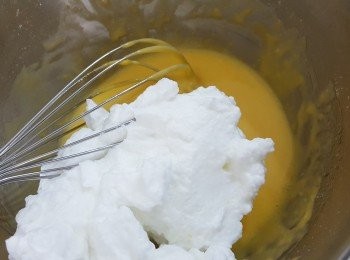 step9: 取三分之一蛋白倒入混合好的<span class="group_1">香橙蛋黃糊材料</span>中，手動打蛋器用提起放下的手式把材料混合均勻